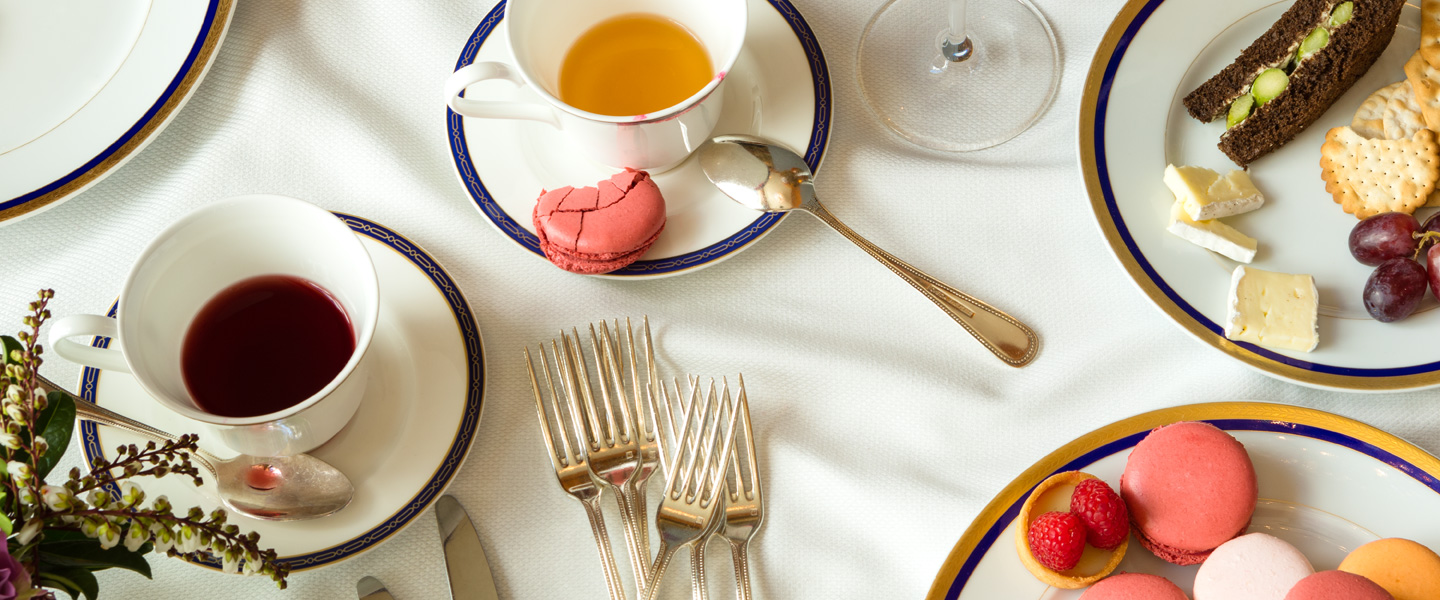 Two cups of tea, marcarons, pastries, and a cheese plate for Afternoon Tea at The Grand America in Salt Lake City.