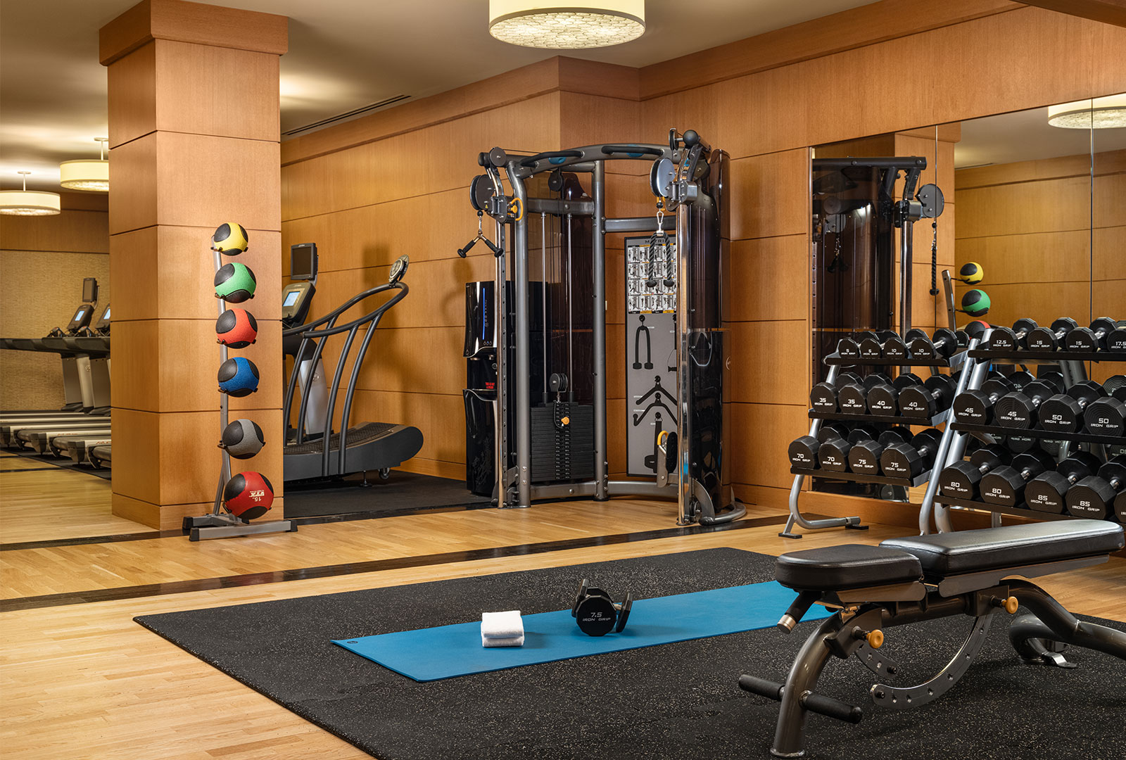 Grand America's Fitness Center featuring cardio equipment, free weights, and strength training stations.